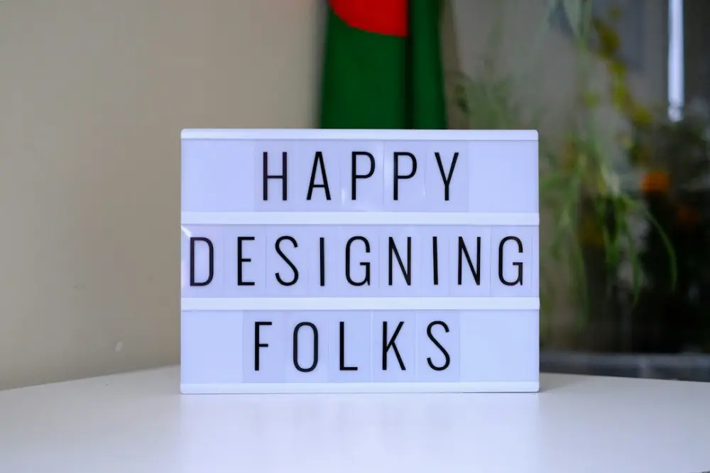 A light box that says happy designing folks, illustrating learning from fabrication and design feedback